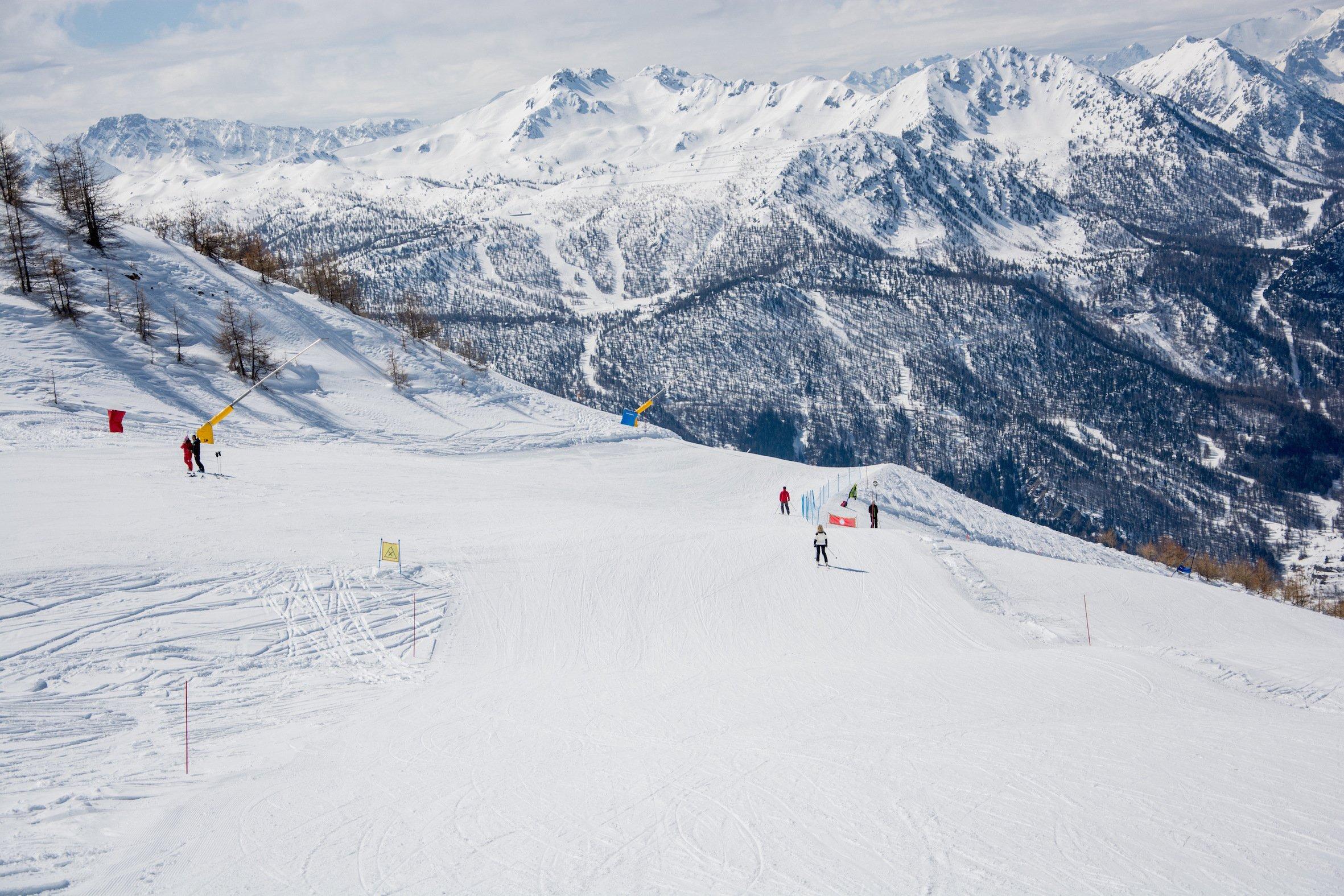 Skiers on a piste in Sestriere on an Italy ski holiday