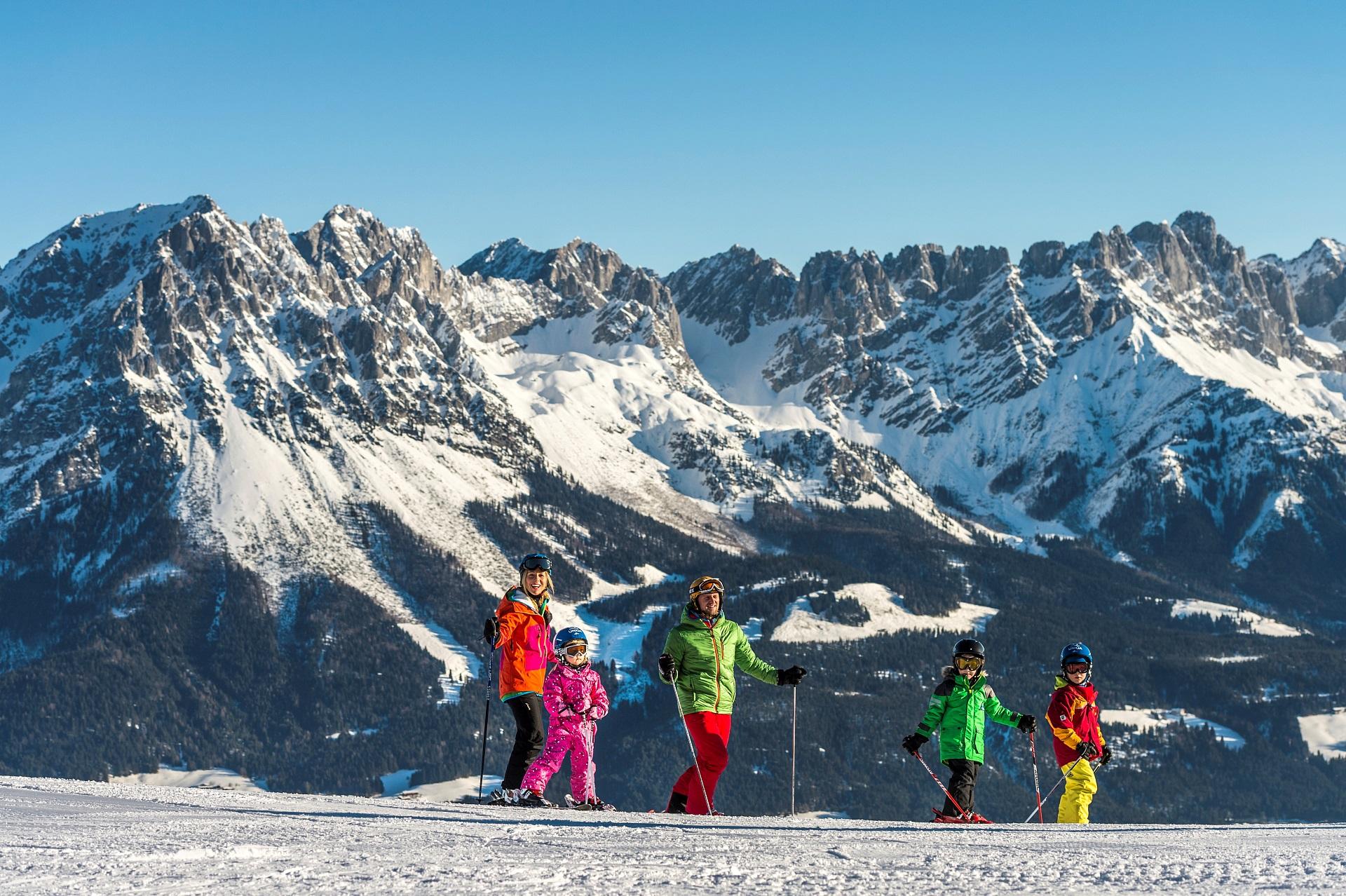 Family of skiers taking break from skiing at Ellmau ski resort in Austria