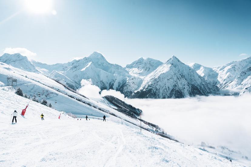Skiers skiing down mountain in les deux alps ski resort