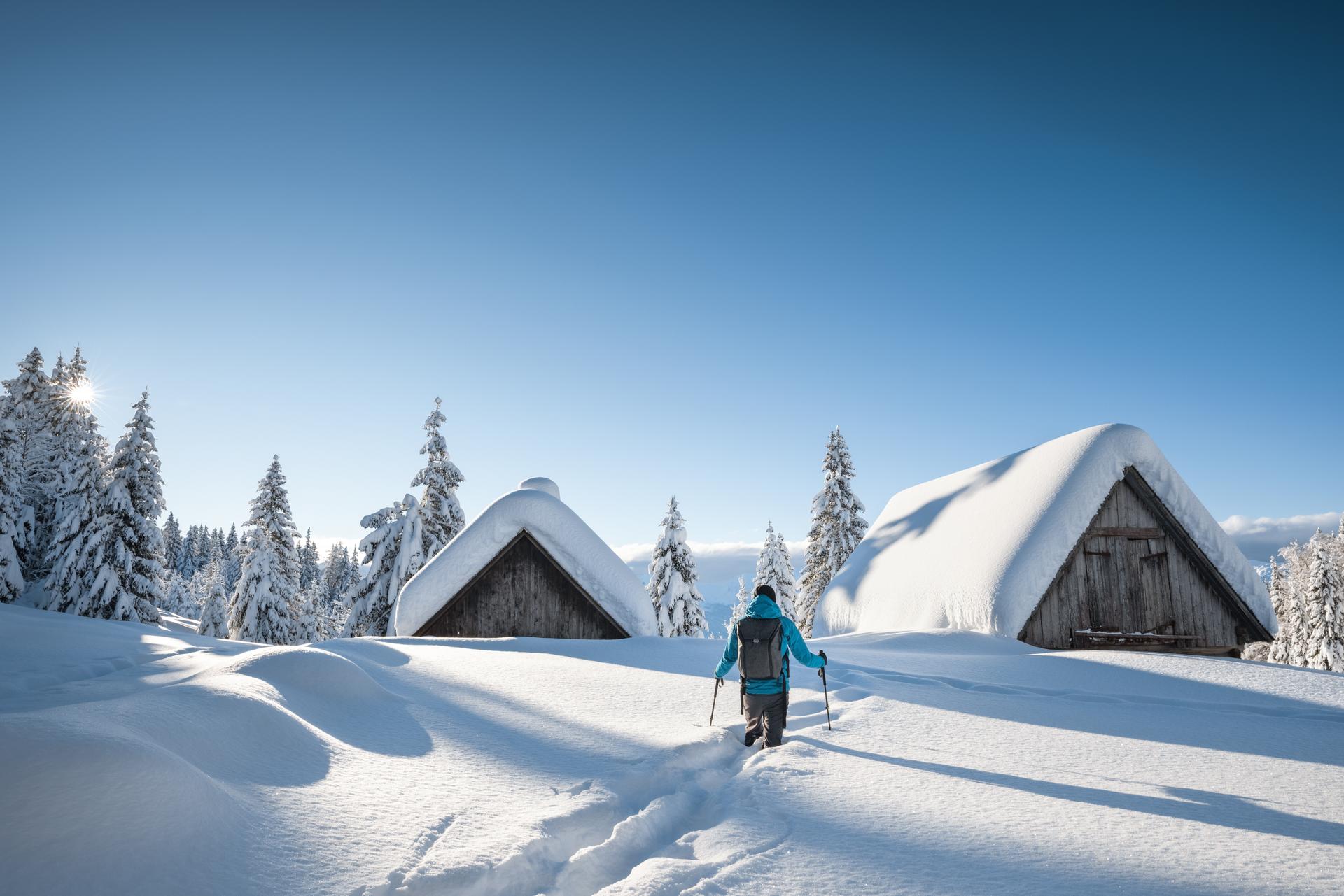 Snowy ski resort with snow capped trees and buildings